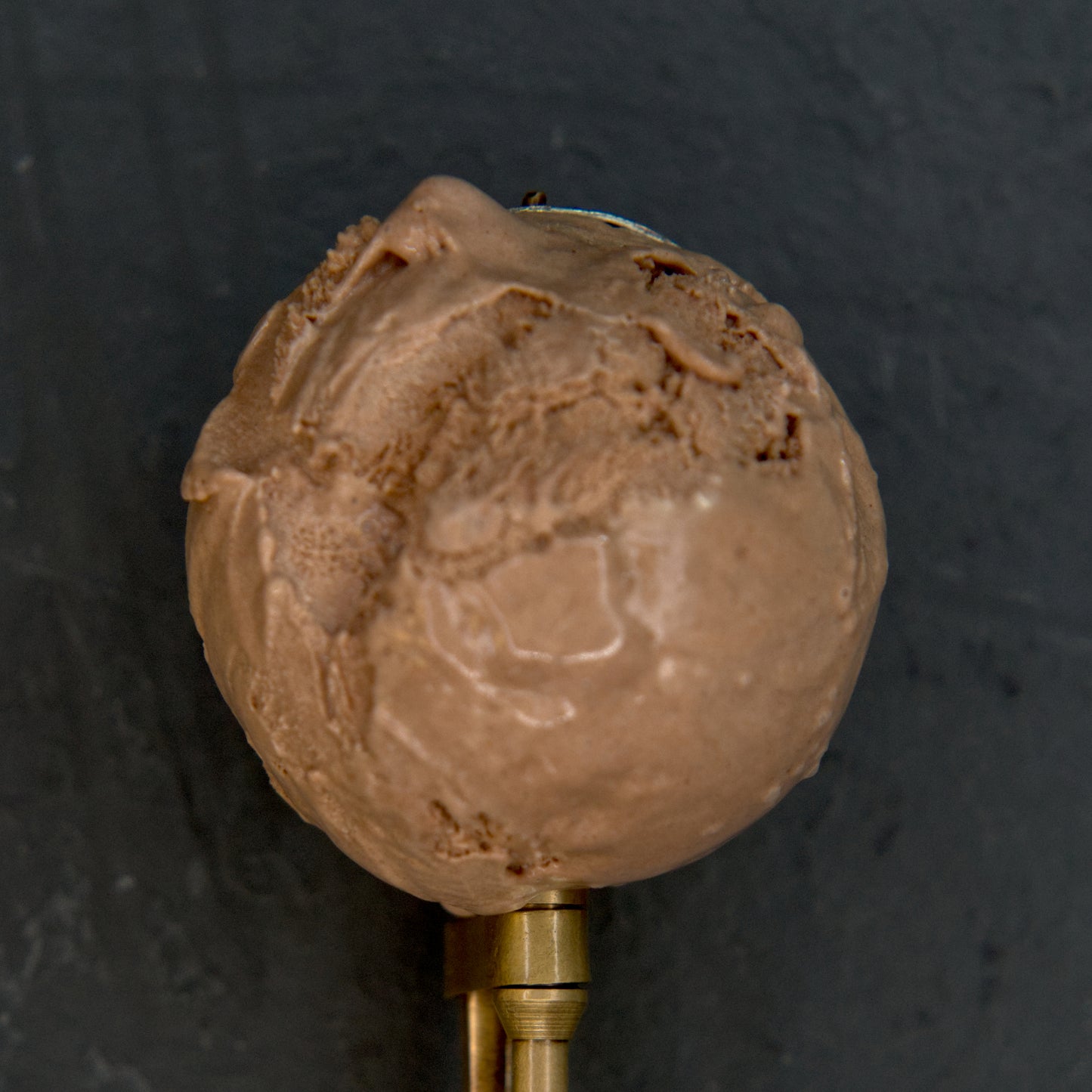 Chocolate ice cream scoop on a dark background