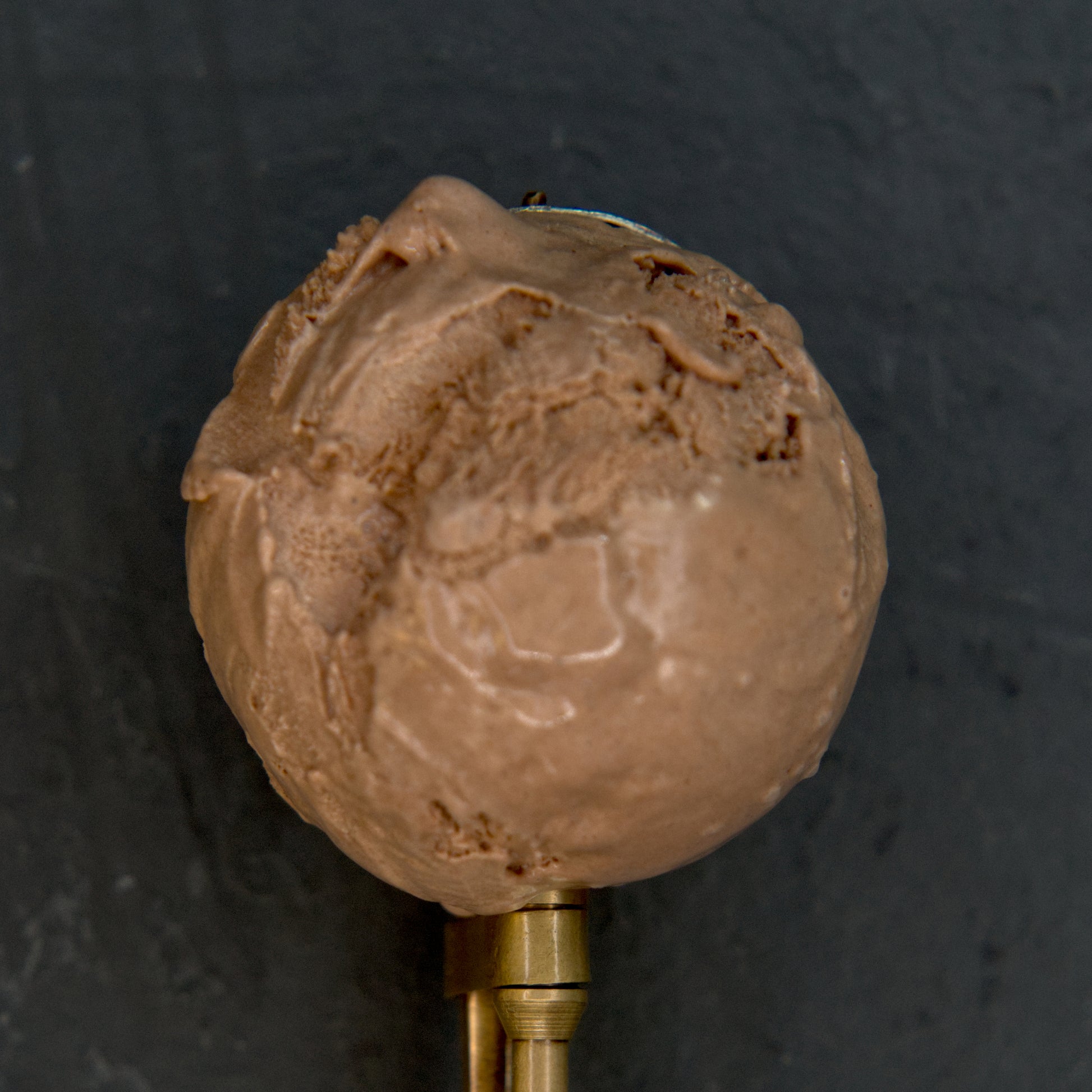 Chocolate ice cream scoop on a dark background