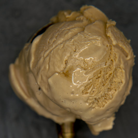 Close-up of a scoop of coffee ice cream on a dark background